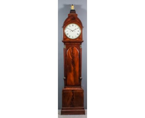 An early 19th Century mahogany longcase clock, the 12ins diameter painted domed metal dial with Roman numerals, to the eight 