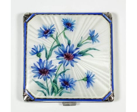 An Elizabeth II silver and enamel square compact, the lid enamelled with blue cornflowers, on a white engine turned ground, t