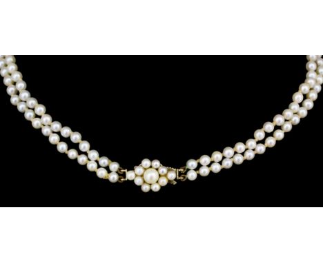 A 1960s twin strand graduated cultured pearl necklace with 9ct gold pearl set clasp, 530mm overall, (gross weight 18 grammes)