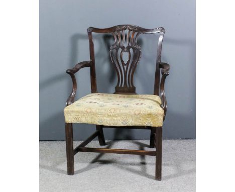 A George III mahogany open armchair of "Chippendale" design, with shaped crest rail, fretted vase pattern splat, shaped arms 