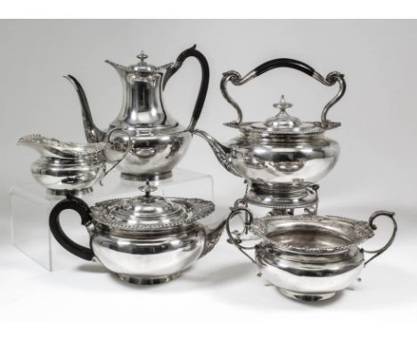 A late Victorian and Edward VII silver five piece tea and coffee service of Georgian design, the plain squat circular bodies 