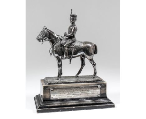 An early 20th Century plated equestrian presentation model of a mounted hussar on ebonised stepped base, with silver engraved