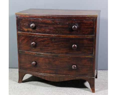 A late Georgian mahogany bow front chest with twin reeded edge to top, fitted three long drawers on shaped apron and splayed 