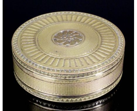 A mid-19th Century Continental gilt metal and tortoiseshell lined circular pattern snuffbox with engine turned petal decorati