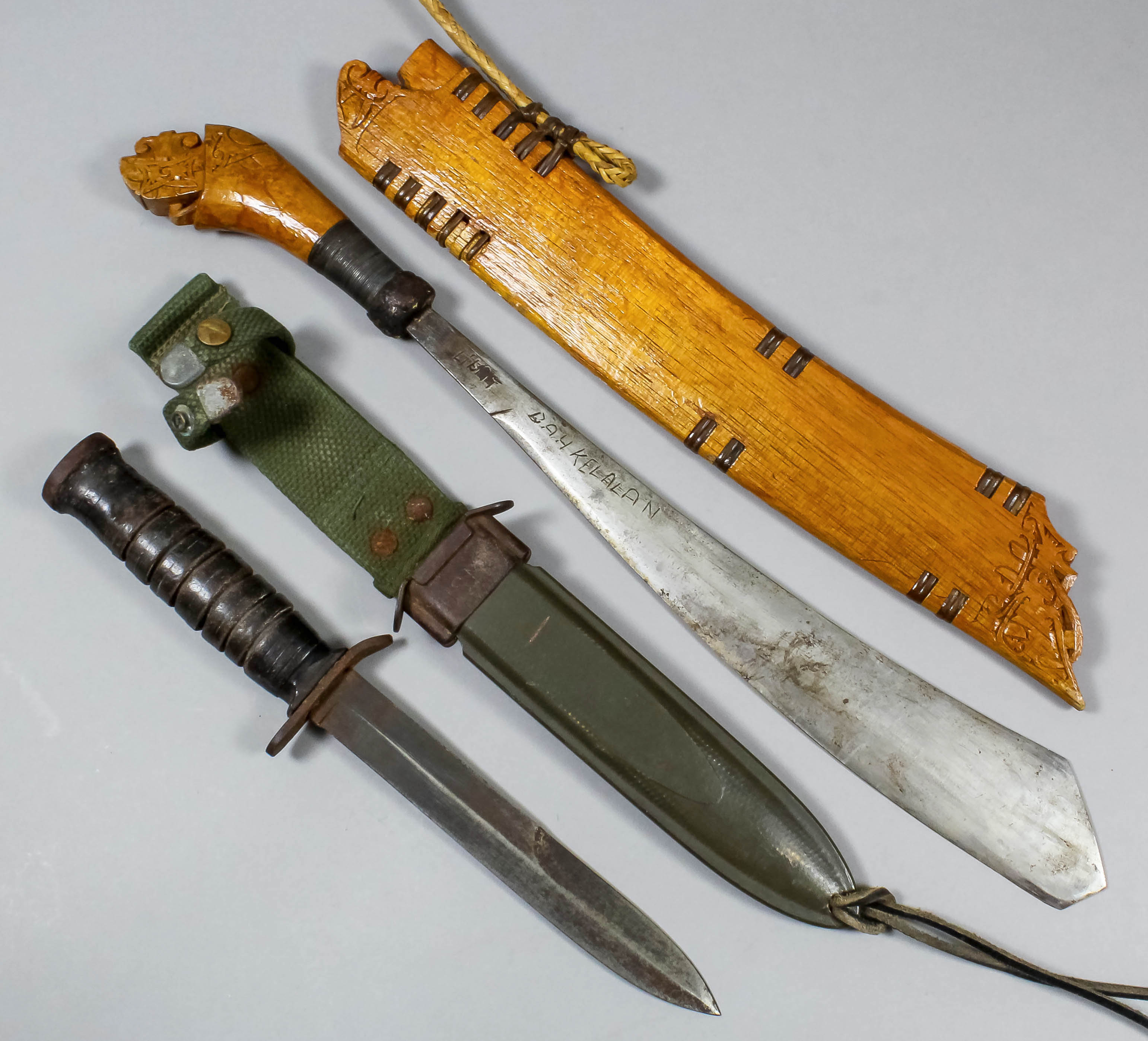 A Malaysian machete style knife, the 12ins blade marked "Bahkelalan