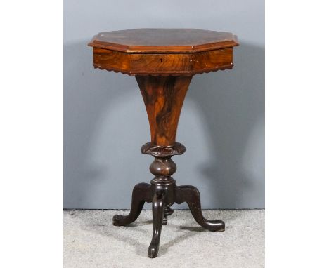 A Victorian figured walnut octagonal work table, the lifting top opening to reveal fitted interior, on tapered column and tri