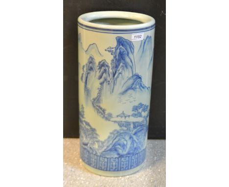 An Oriental blue and white stick stand decorated with mountain village scenes.