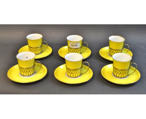 A set of six demitasse coffee cups and saucers, yellow liner with silver pierced mounts