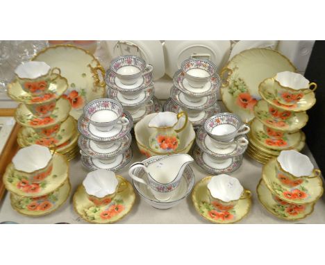 A Staffordshire tea service for twelve, scalloped shaped decorated with poppies and gilding,comprising a pair of bread and bu