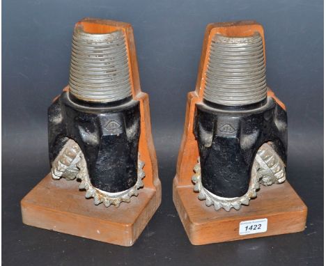 A pair of novelty bookends, mounted with oil drill bits