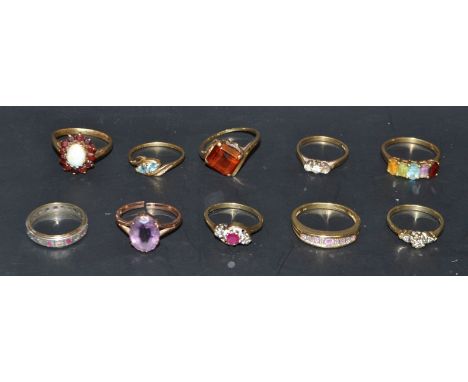 A 9ct gold ring set with a single faceted amethyst, other 9ct gold dress rings, mostly set with stones, some semi-precious in