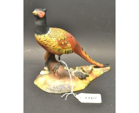 A Royal Crown Derby pheasant model, hand painted with hand applied black berries and leaves to base, signed.