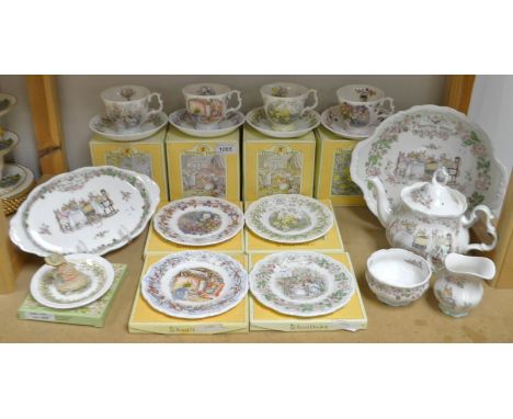 A Royal Doulton Brambly Hedge teapot milk and sugar, set of four The Seasons pattern teacups, saucers and tea plates, bread a