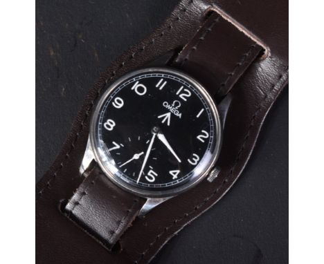 A WWII Second World War British Military issue Navy Fleet Air Arm pilots Swiss made Omega wrist watch. Black dial with Arabic