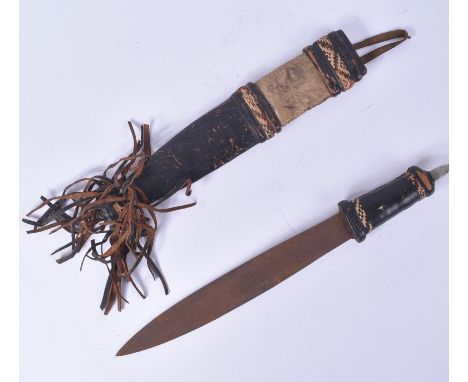 A 19th Century Sudanese tribal leather clad double edged dagger / knife. Housed within its original leather and hide scabbard