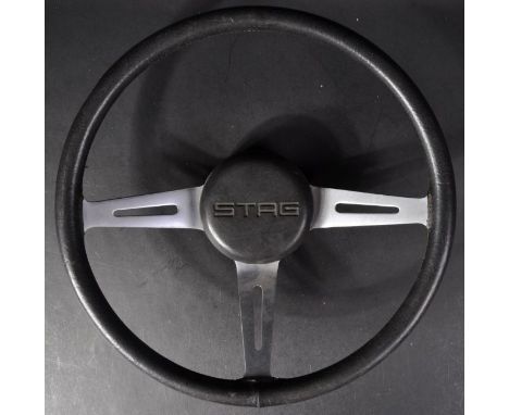 Automobilia - a vintage (1970's) Triumph Stag classic car steering wheel featuring black leather covered rim with x3 stainles