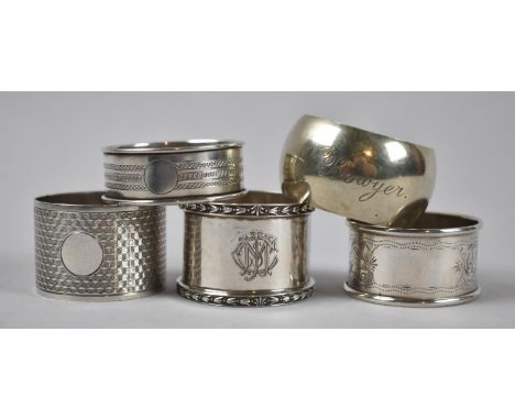 A Collection of Four Silver and One Metal Napkin Rings 