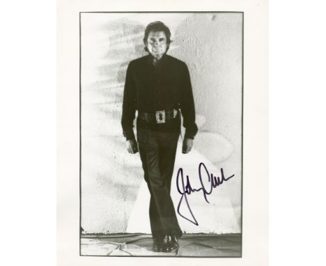 CASH JOHNNY: (1932-2003) American Singer & Songwriter. Signed 8 x 10 photograph by Cash, the image depicting the Singer stand