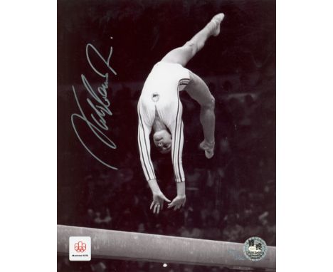 COMANECI NADIA: (1961- ) Romanian Gymnast. Five times Olympic individual gold medallist. Comaneci is the first Gymnast to be 