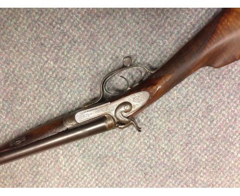William Ford, a 16 bore hammer gun, No 165 (Barrel No. 12767), with 28" barrels, the frame with scroll engraving, rotary unde