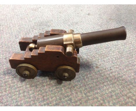 A model canon, 19th century, with 15.5cm bronze barrel on shaped wooden carriage and four disc wheels 20cm (8in)  