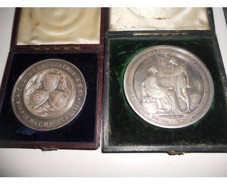 Four cased medallions: A City of London School, 1834, silver medal, 3.4oz together with another City of London School medal, 