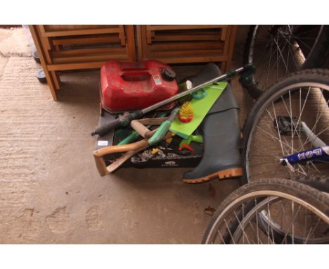 A box containing various gardening tools, petrol can, and a pair of size 4 wellington boots