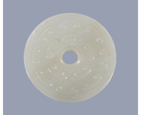  A Chinese white jade disc  ,  bi  , carved with scrolls, 5.2cm diameter Provenance: Property from a deceased estate.  