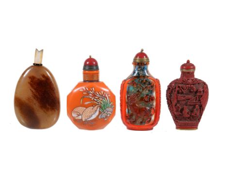  A Chinese brown jade snuff bottle  , with darker brown inclusions, 6.3cm high and three other snuff bottles, between 7cm and