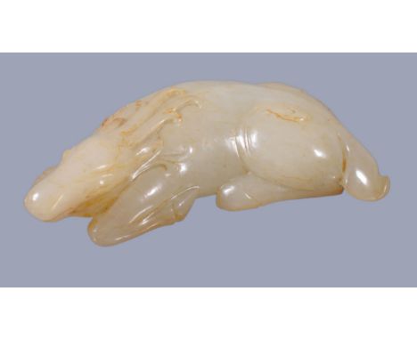  A Chinese white jade carving of a deer,   with russet inclusions, recumbent and carved with antlers and other details, 7.2cm