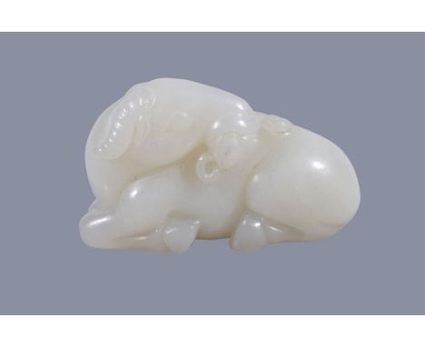  A Chinese white jade ram,   well carved with its head turned back and holding a  lunzhi   fungus in its mouth, 4.1cm wide x 