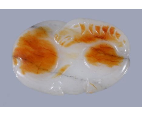  A Chinese white and russet jade horse buckle  , carved as a reclining horse, 6.7cm wide x 4.5cm high  