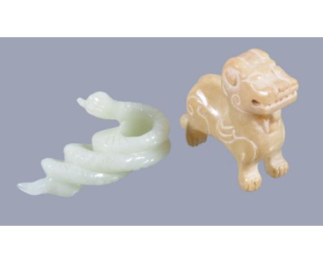  A celadon jade carving of a snake  , 6cm long and  a Chinese archaic style stone model of a lion  , 5.5cm long, fabric cover