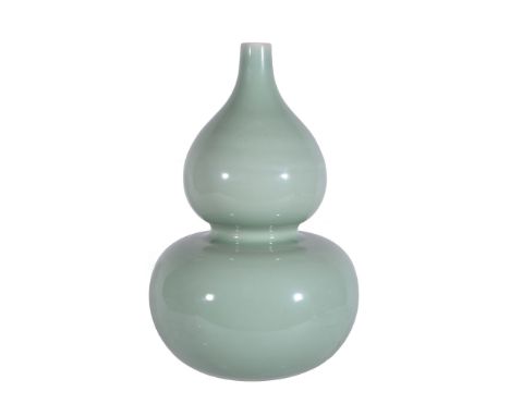  A Chinese celadon-glazed double-gourd vase,   elegantly potted with a globular lower bulb supporting a slightly smaller uppe