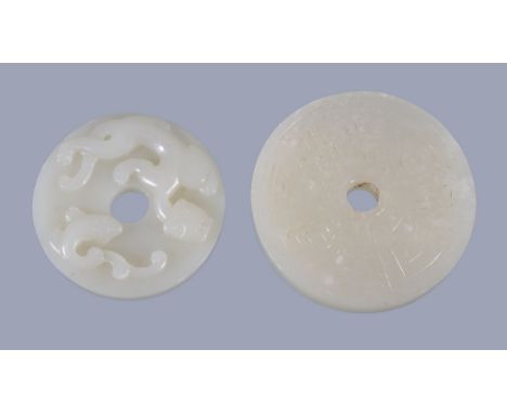  A Chinese wide jade 'chilong' disc  , bi, 4.7cm diameter and  a Chinese white jade disc  , one side carved with a goose, 5.5