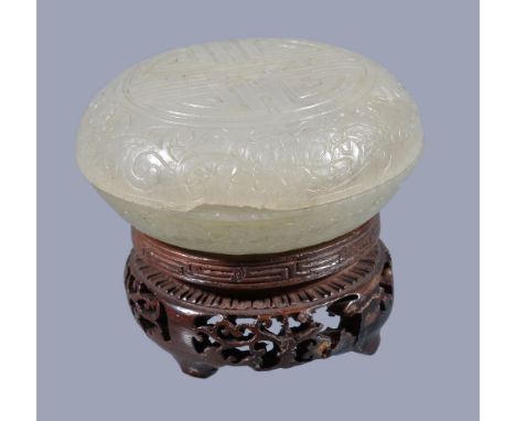  A Chinese pale celadon jade 'shou' circular box and cover,   Qing Dynasty, of circular form supported on a circular footring