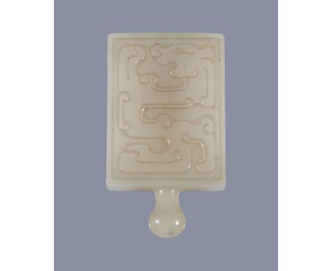  A Chinese white jade buckle, carved with archaic designs,   4.5cm high   Provenance: Property from a deceased estate.  