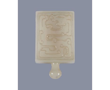  A Chinese white jade buckle, carved with archaic designs,   4.5cm high   Provenance: Property from a deceased estate.  