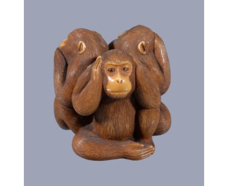 Ω A Japanese ivory Netsuke/Okimono of The Sanbikisaru , the three apes seated back to back in a circle, each posed in the tra