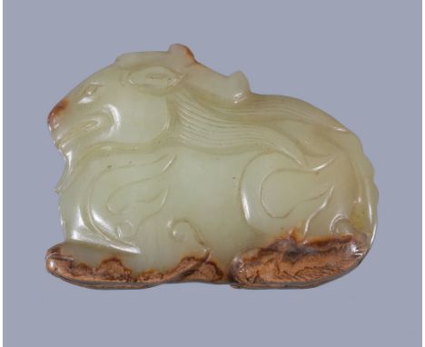  A Chinese yellow and russet jade goat pendant  , the reclining animal carved with details, 4.5cm long x 3.3cm high  