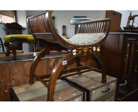 AN EDWARDIAN MAHOGANY AND INLAID CROSS FRAMED STOOL on a stretchered base