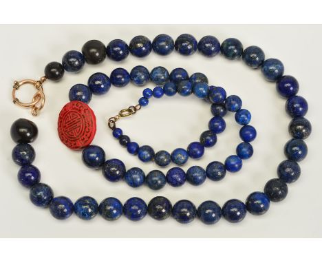 TWO SINGLE ROW LAPIS LAZULI BEAD NECKLACES, the first designed as a near uniform row of spherical lapis lazuli beads, with th