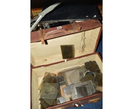 A BLACK METAL DEED BOX, (key), with a suitcase containing a collection of glass slides (magic lantern slides?), also framed a