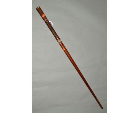 A WOODEN WALKING STICK/PACING STICK, approximate 88cm in length, with metal tip and gold coloured pommell, the stick has been