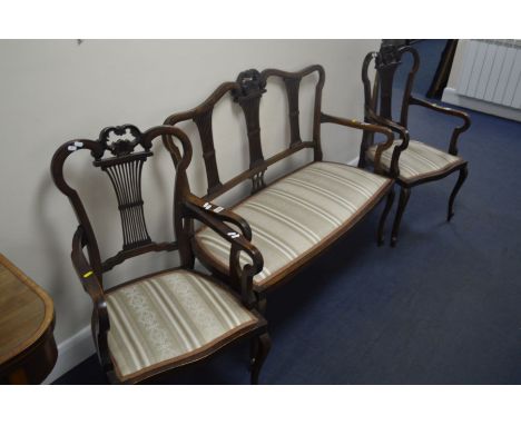 AN EDWARDIAN MAHOGANY SALON SUITE, with foliate decoration and spindled splat backs, comprising of a two seater settee and a 