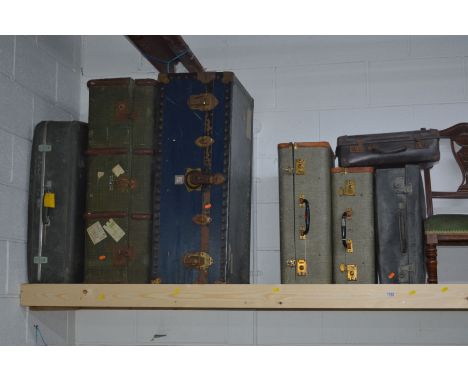 A BLUE GROUND SHIPPING TRUNK, together with a travelling trunk and five various suitcases (7)