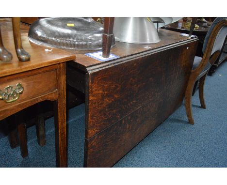 A GEORGIAN OAK DROP GATE LEG TABLE, width 107cm