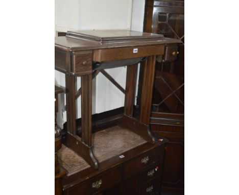 A VINTAGE ELECTRIC SINGER SEWING MACHINE ON STAND with two narrow drawers flanking a long central drop down drawer, 87cm widt