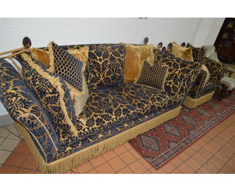 A FOLIATE DECORATED BLUE AND GOLD UPHOLSTERED KNOLE TWO PIECE SUITE, with acorn wooden finials, comprising of a large two sea