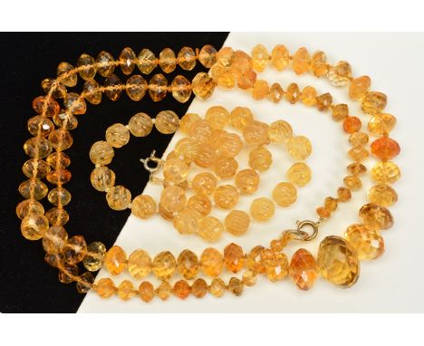 TWO CITRINE BEAD NECKLACES, the first designed as a uniform single row of carved spherical beads, the second designed as a gr